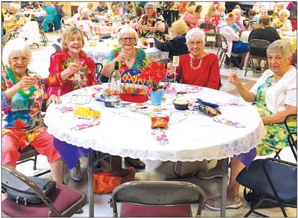 Club celebrates luncheon with Hawaiian themes