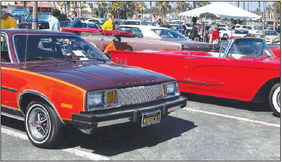 A colorful sunset beach car show