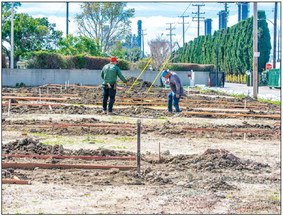 Crews install plot markers at gardens